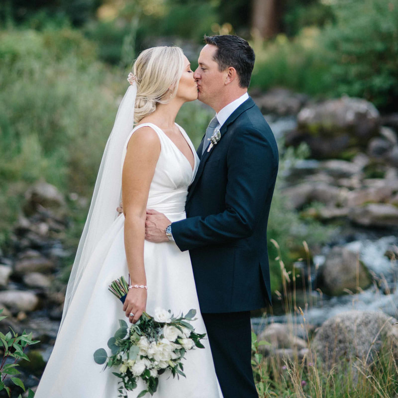 bride and groom portrait, groom kissing bride's forehead, beaver creek chapel wedding, couples portraits along creek, mountain wedding inspiration, colorado wedding planning, sweetly paired planners