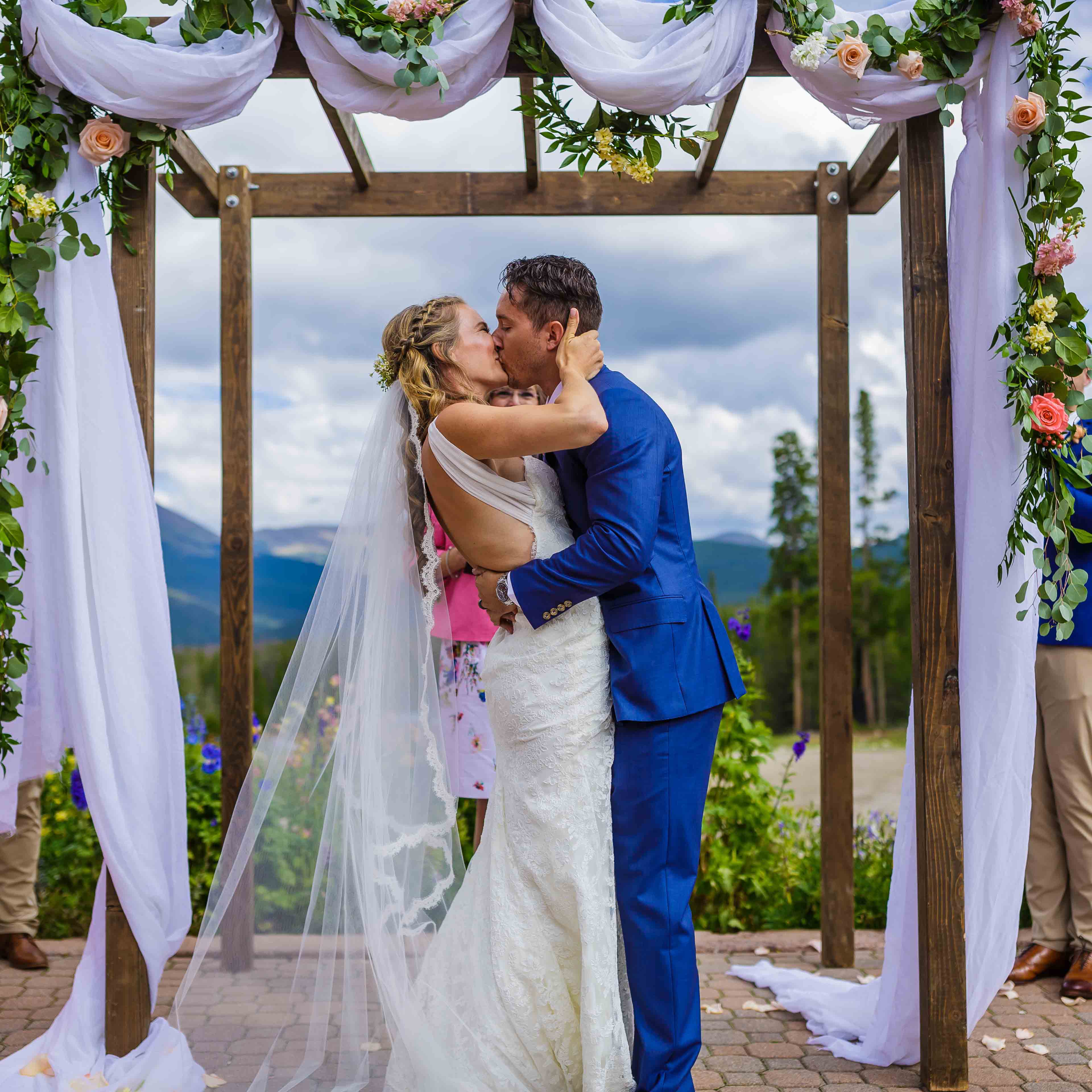 bright wedding photography, Breckenridge wedding planner, first kiss, outdoor ceremony under chuppah at ten mile station, mountain wedding inspiration