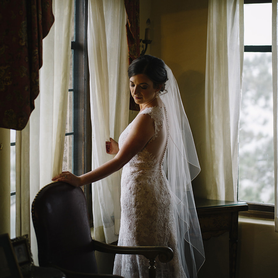 bridal portrait, window light in getting ready room, bridal suite at cherokee ranch and castle, sweetly paired wedding planner, colorado wedding inspiration