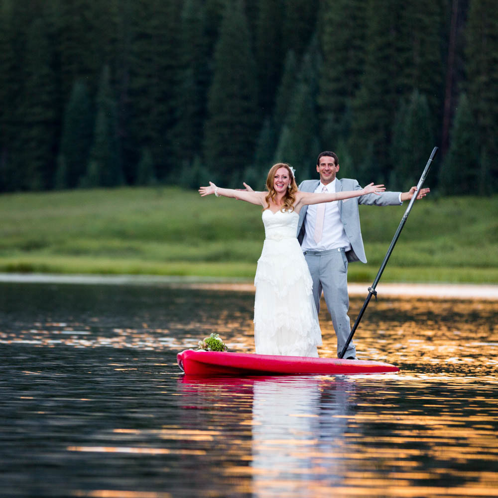 bride and groom chelebrating on stand up paddle board, SUP, wedding mountain inspiration, beaver creek wedding planner, vail wedding planning, sweetly paired weddings, piney river ranch real wedding