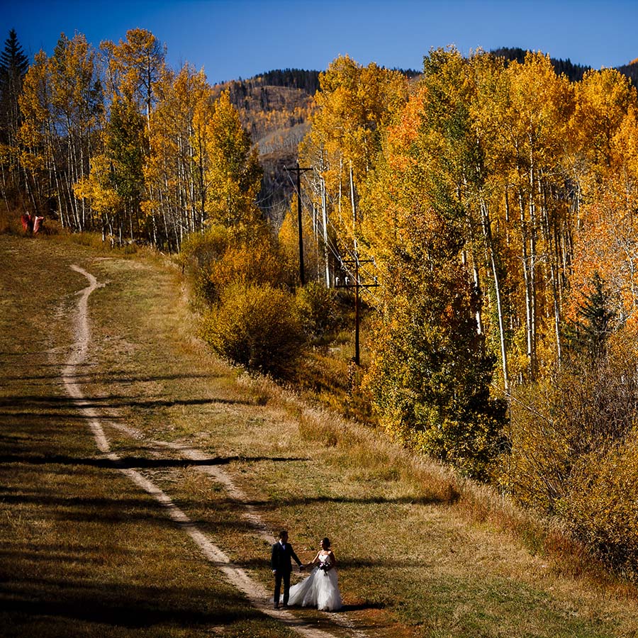 bride and groom walking up ski trail vail, autumn mountain wedding inspiration, vail wedding planning, colorado wedding planner, sweetly paired weddings