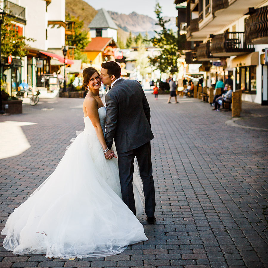 bride and groom kissing, vail village, colorado wedding inspiration, mountain wedding planner, destination wedding planner