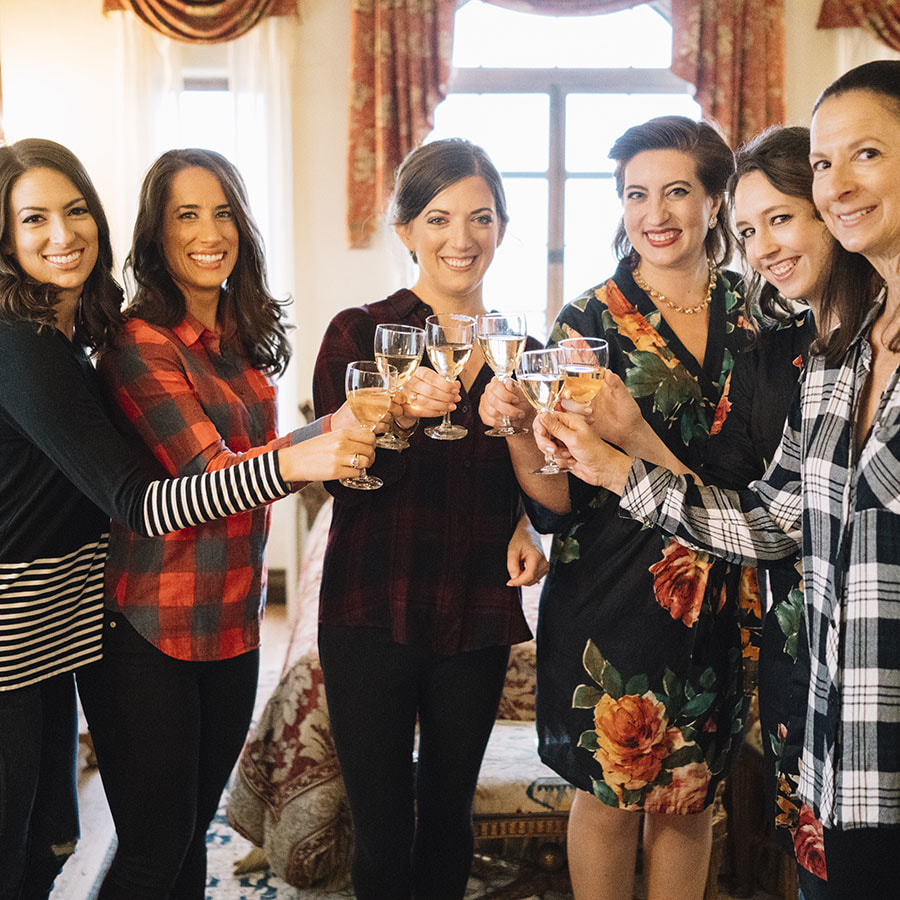 bride and bridesmaids toasting champagne in bridal suite at cherokee ranch, girls getting ready, real weddings, mountain wedding planner, colorado wedding planning