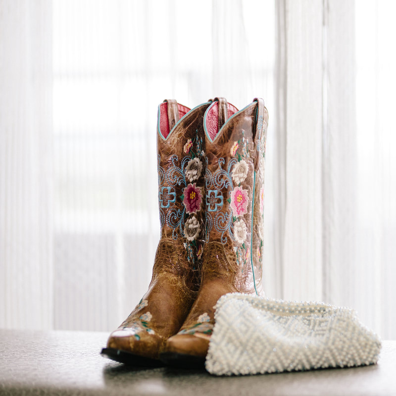 Bride getting ready photo, embroidered wedding cowboy boots, white pearl bridal clutch, detail photos, denver wedding planner, colorado wedding planner, spruce mountain ranch alberts house