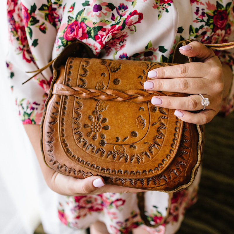 Bride getting ready photo, floral bridal robe, hand tooled leather purse, detail photos, denver wedding planner, colorado wedding planner, spruce mountain ranch alberts house