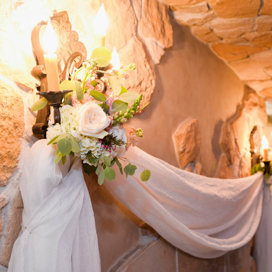 indoor ceremony decor, floral and draping on stucco wall, baldoria on the water wedding venue, denver wedding inspiration, denver wedding planner, colorado wedding inspiration, sweetly paired wedding planning