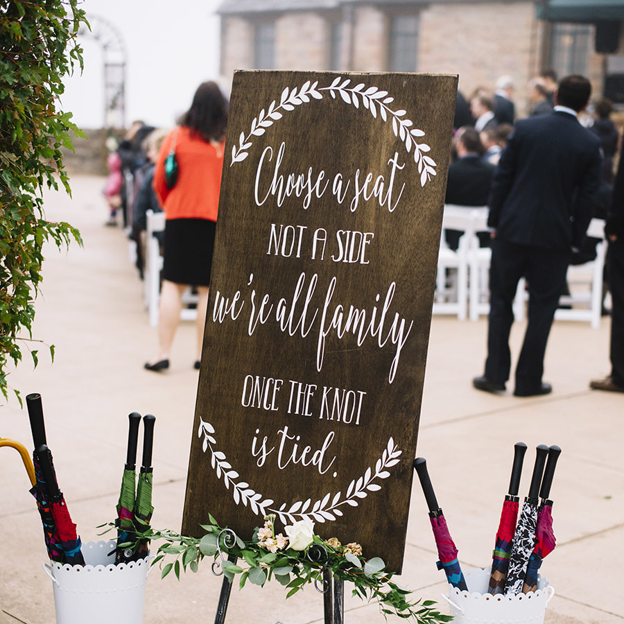 choose a seat not a side ceremony wood sign on easel, umbrellas in white metal buckets, ceremony details, cherokee ranch weddings, real weddings, mountain wedding planning, colorado wedding inspiration