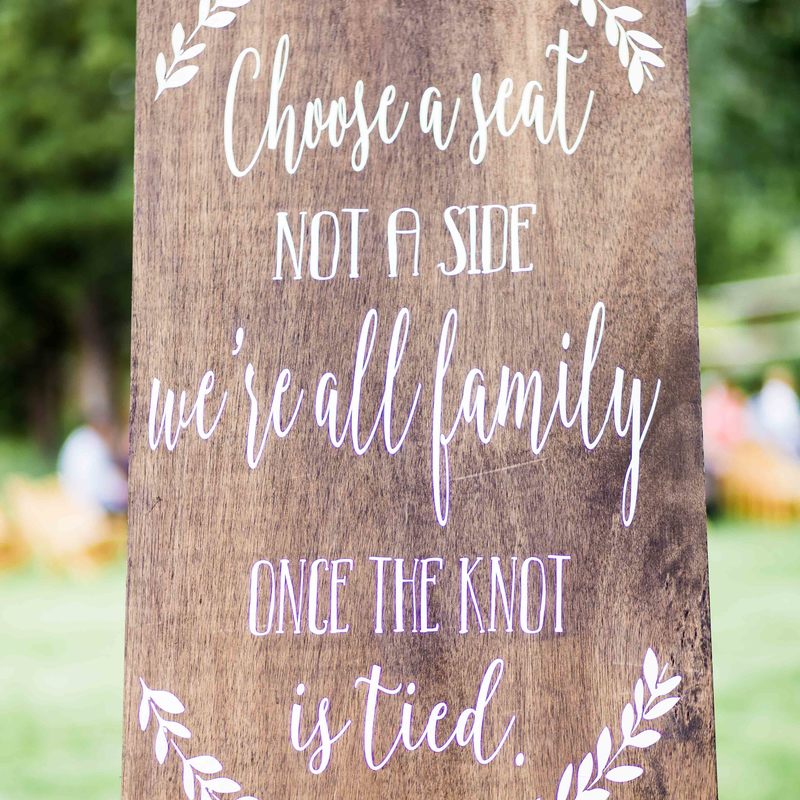 spruce mountain ranch wedding ceremony, detail photo of ceremony, aisle decor, sweetly paired wedding planning, colorado wedding planner, mountain wedding inspiration, wooden sign, choose a seat not a side