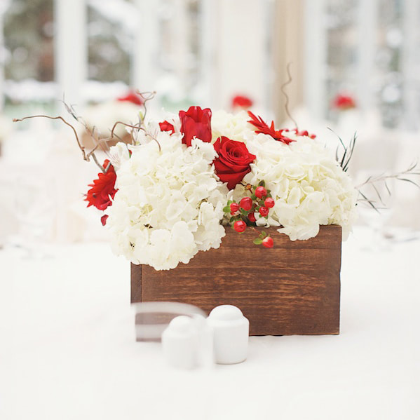 Red floral centerpieces in square wooden boxes, reception detail photos at sonnenalp, vail wedding planning, colorado wedding planner, destination wedding planner, sweetly paired weddings, mountain wedding inspiration, christmas themed wedding decor, winter weddings
