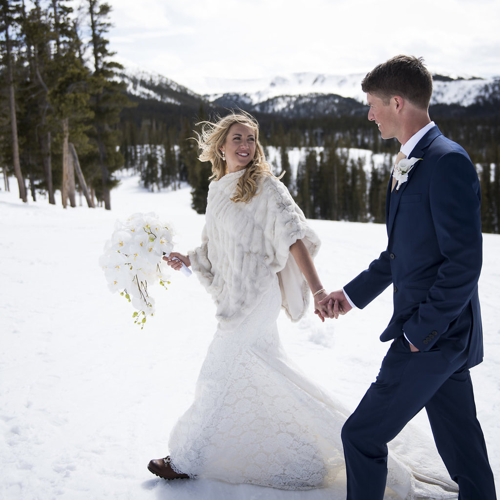 Bride and groom walking holding hands in the snow, mountain wedding planner, colorado wedding planner, real weddings, sweetly paired, winter wedding inspiration, destination wedding planner