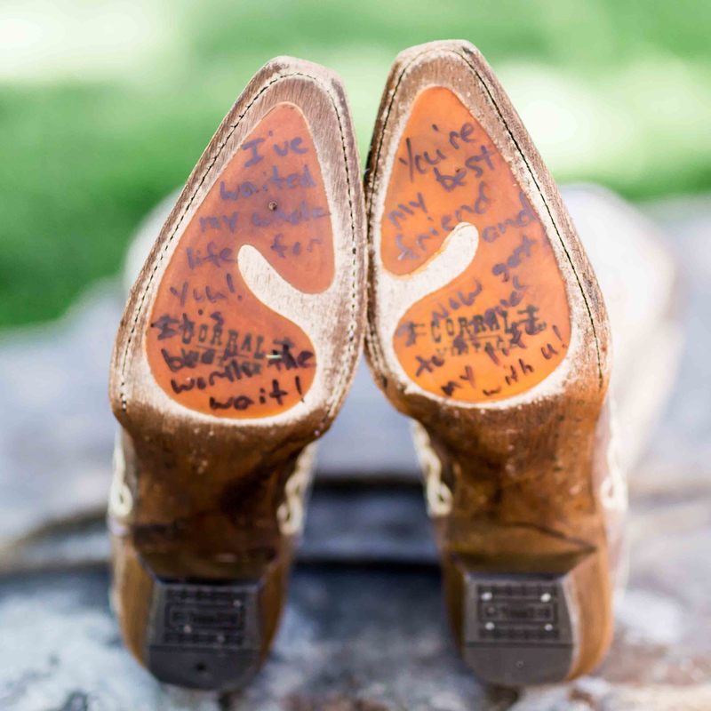 bride getting ready detail photos, spruce mountain ranch, message written on bottom of shoes, bride's cowgirl boots, real weddings, mountain weddings, colorado wedding planner, rustic barn wedding planning