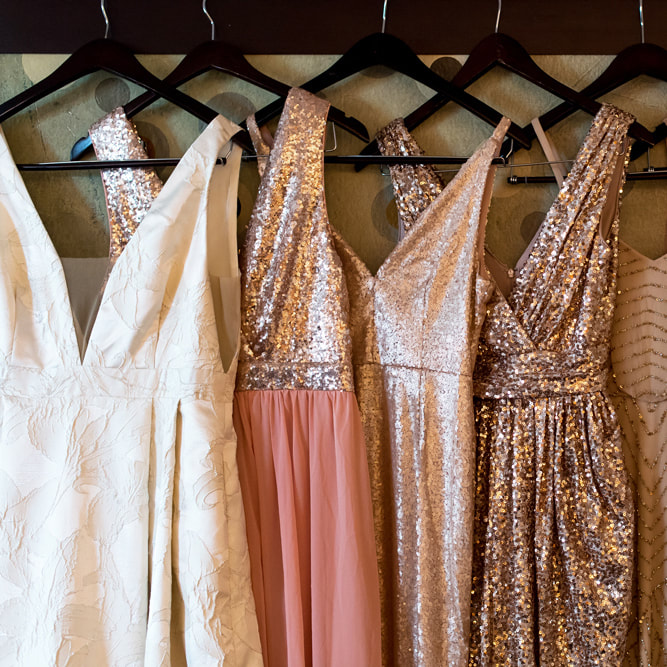 Bride getting ready photo, detail photos, denver wedding planner, colorado wedding planner, sweetly paired, bride and bridesmaids gowns hanging together, metallic bridesmaids gowns, rose gold