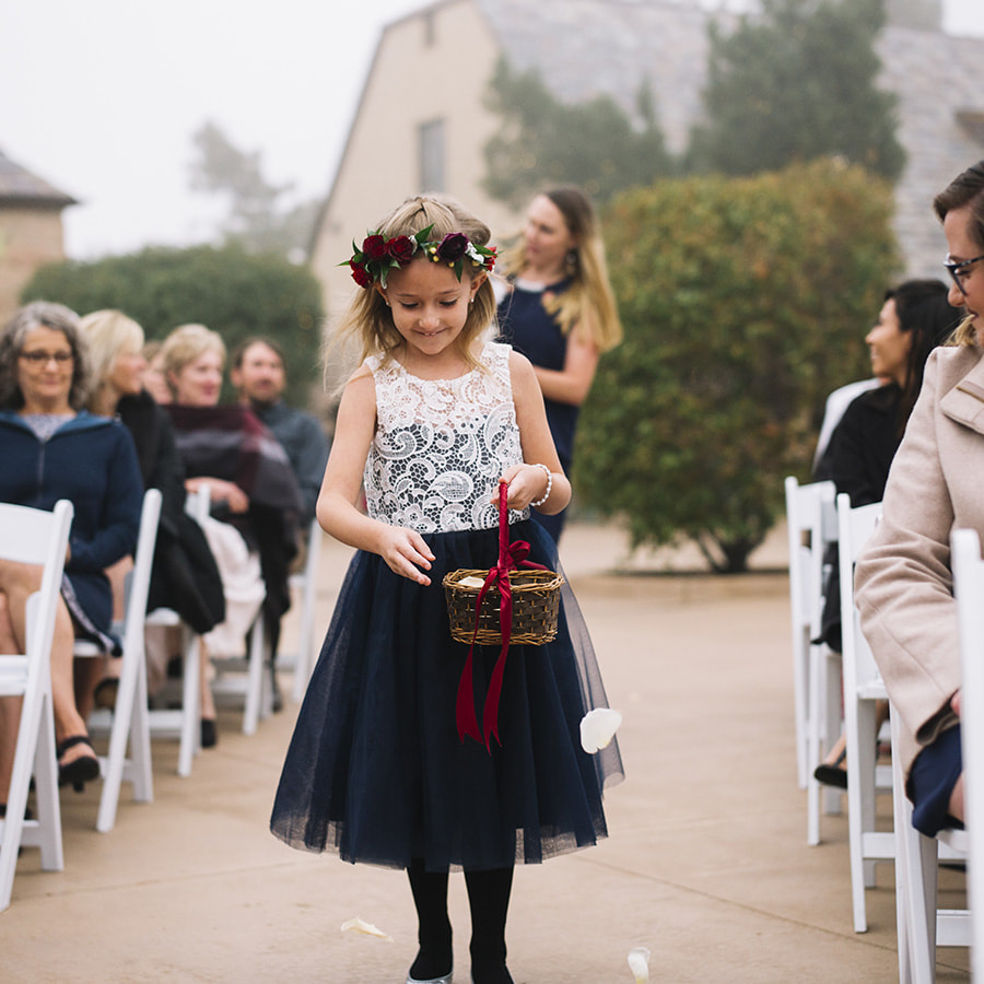 cherokee ranch outdoor ceremony, processional, flower girl walking down the aisle, throwing petals, navy and white flower girl dress, flower crown, colorado mountain wedding, sweetly paired wedding planners, autumn wedding inspiration