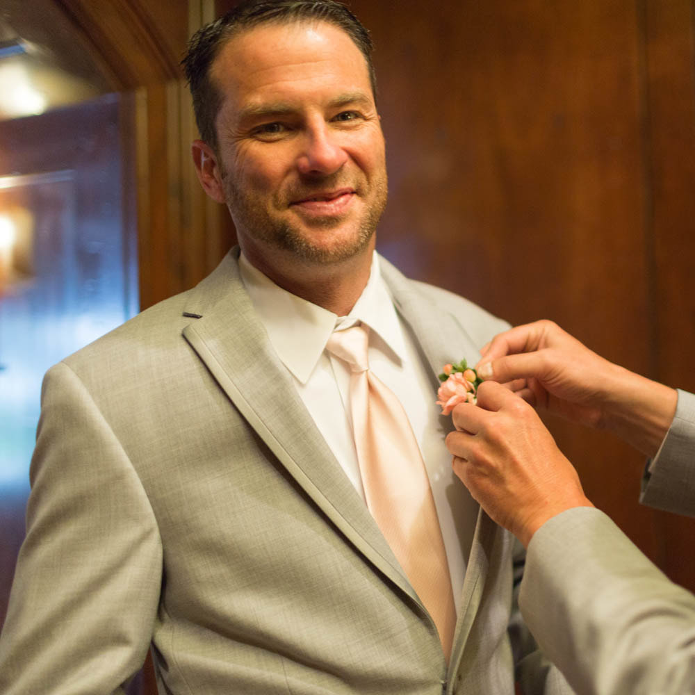 groom getting ready, pinning boutonniere, piney river ranch, colorado mountain wedding planning, vail wedding planners, sweetly paired weddings