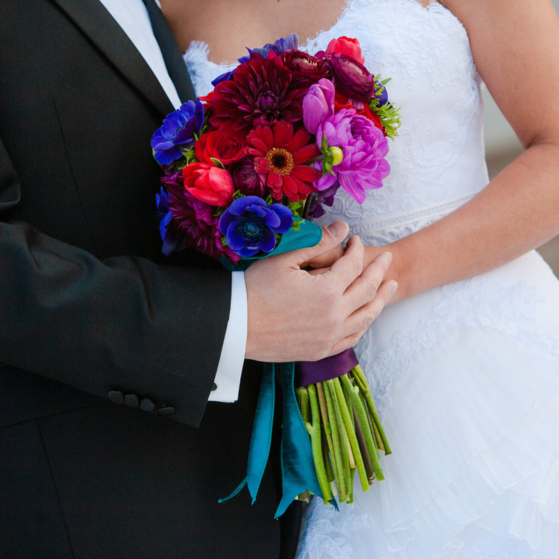 Bride and groom holding bridal bouquet, chateaux at fox meadows, denver wedding planner, colorado wedding planner, sweetly paired, bold wedding colors, winter wedding inspiration