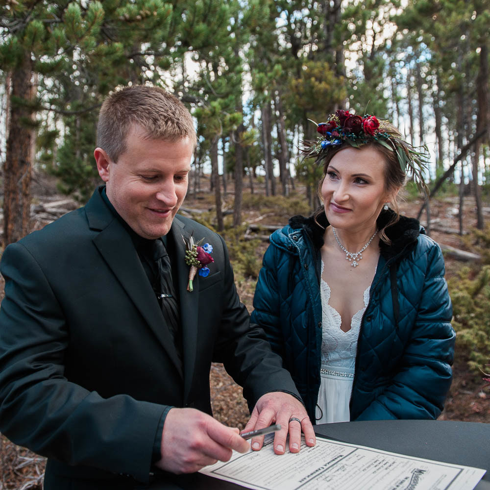 signing the marriage license, Sapphire Point destination elopement, detail photos, ceremony details, breckenridge wedding, mountain wedding planner, colorado wedding inspiration, sweetly paired elopement planning, winter wedding inspiration