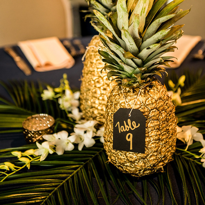 table decor, gold pineapple centerpieces, palm fronds, gold navy and green wedding colors, cielo at castle pines reception, colorado wedding inspiration, mountain wedding planner