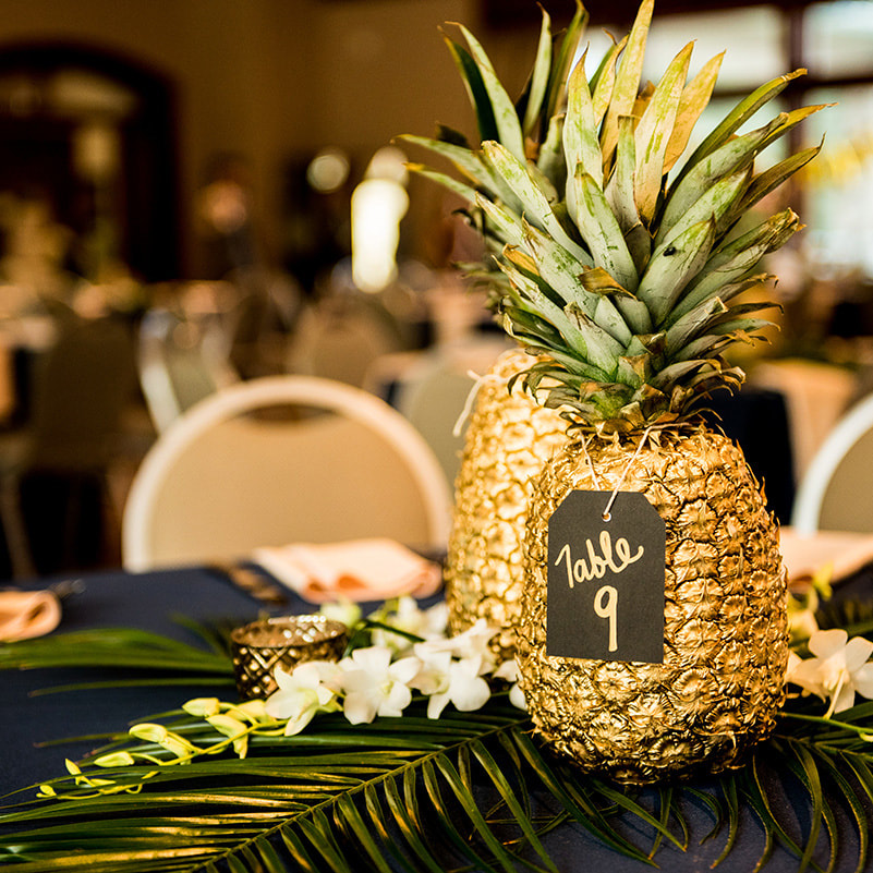 reception table decor, gold pineapple centerpieces, palm fronds, gold navy and green wedding colors, cielo at castle pines reception, colorado wedding inspiration, mountain wedding planner
