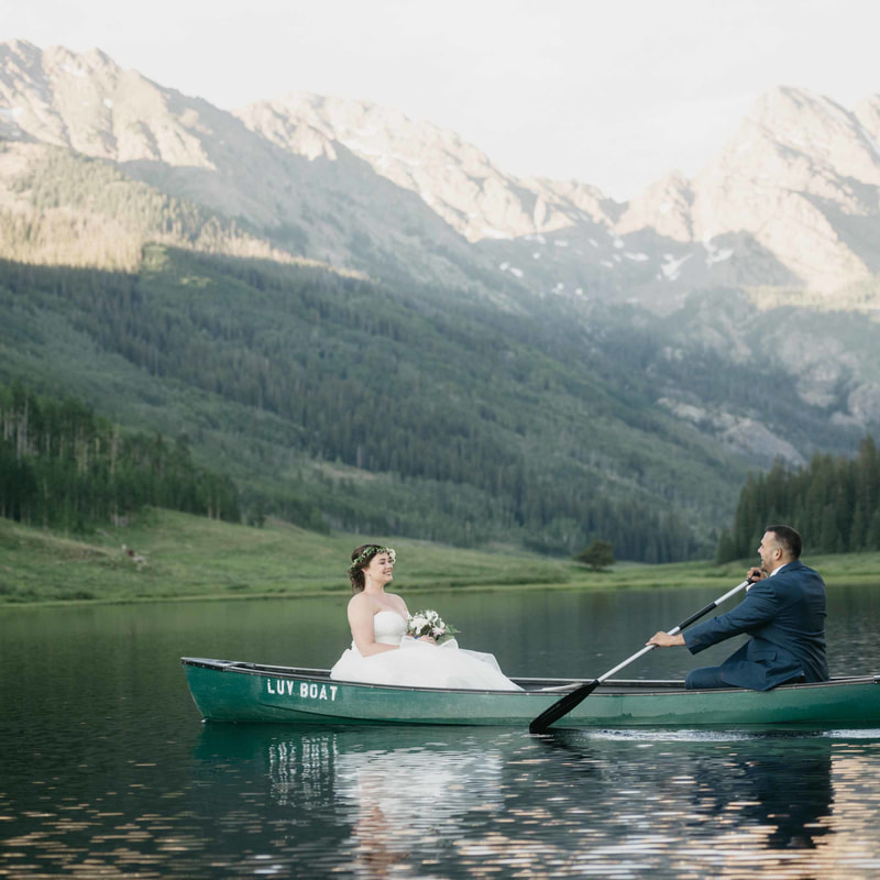 bride and groom in canoe on lake at piney river ranch, colorado mountain wedding planning, vail wedding planners, sweetly paired weddings