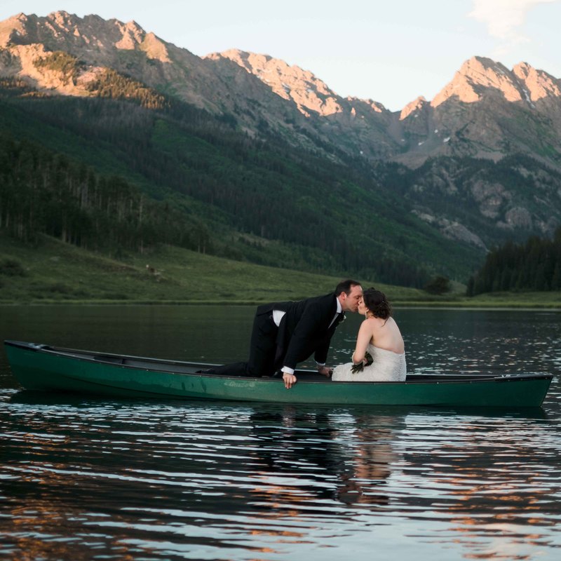 bride and groom kissing in canoe, wedding mountain inspiration, beaver creek wedding planner, vail wedding planning, sweetly paired weddings, piney river ranch real wedding