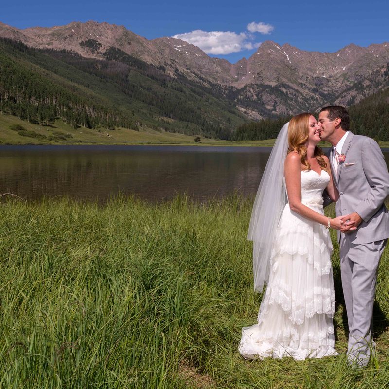 bride and groom portrait, groom kissing bride on the cheek next to mountain lake, wedding mountain inspiration, beaver creek wedding planner, vail wedding planning, sweetly paired weddings, piney river ranch