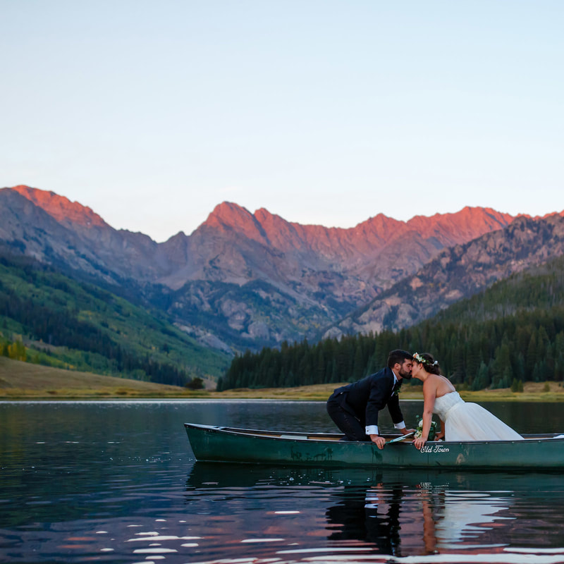 bride and groom kissing in canoe on lake at piney river ranch, colorado mountain wedding planning, vail wedding planners, sweetly paired weddings
