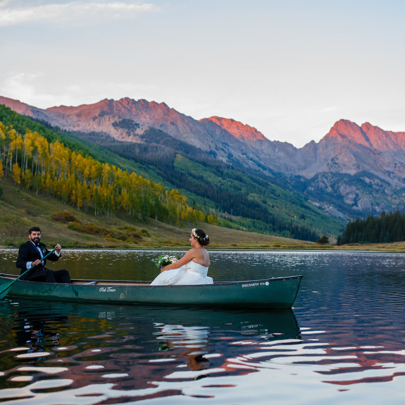 bride and groom rowing canoe on lake at piney river ranch, glamping wedding, mountain wedding inspiration, vail wedding planners, sweetly paired weddings