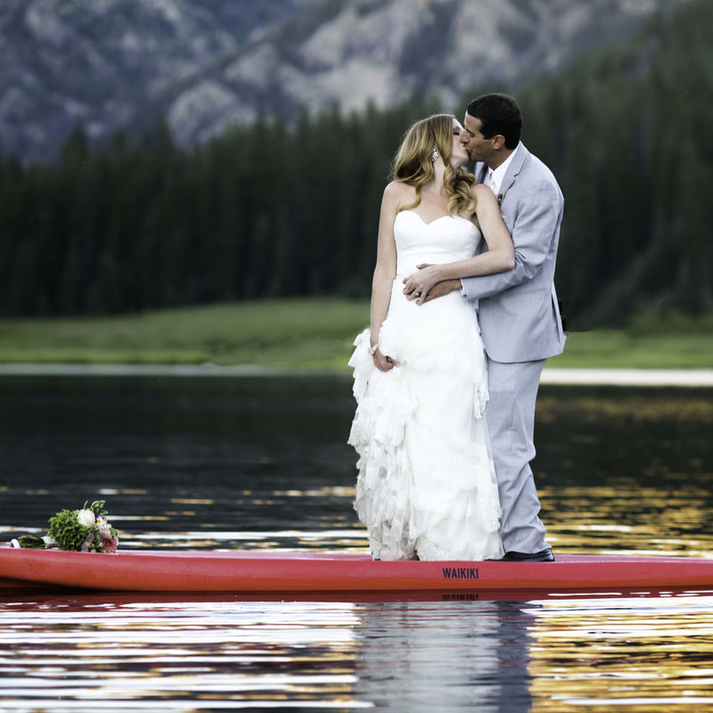 bride and groom kissing on stand up paddle board, SUP, wedding mountain inspiration, beaver creek wedding planner, vail wedding planning, sweetly paired weddings, piney river ranch real wedding