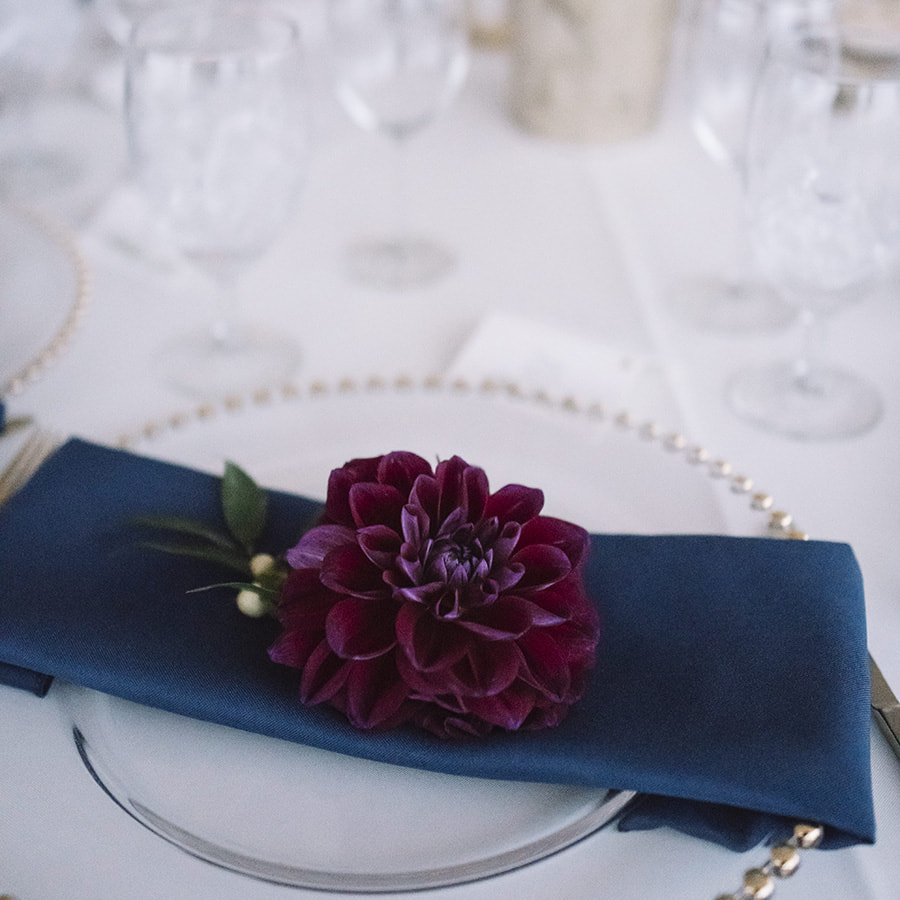 navy and gold wedding colors, table setting with floral sprigs, cherokee ranch and castle wedding planner, colorado wedding planning, mountain wedding inspiration