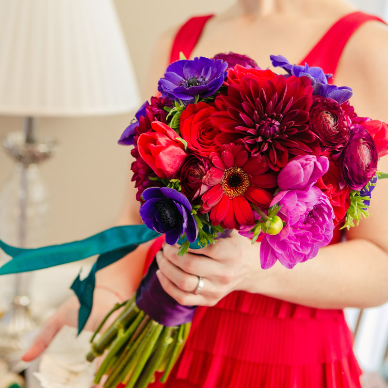 bridesmaid in red gown holding Bridal bouquet, denver wedding planner, colorado wedding planner, chateaux at fox meadow weddings, sweetly paired, bold colors wedding inspiration