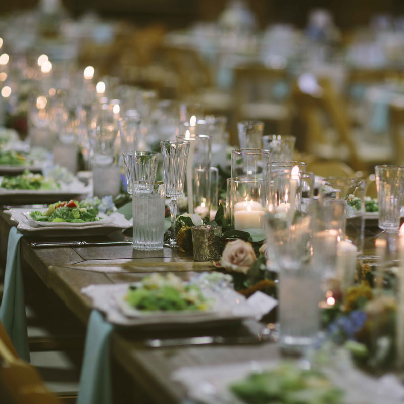 table decor centerpieces, spruce mountain ranch reception space, white and green wedding colors, rustic chic barn wedding, plated salad, robins egg blue linens, candle lit decor, colorado wedding inspiration, mountain wedding planning, denver wedding planner