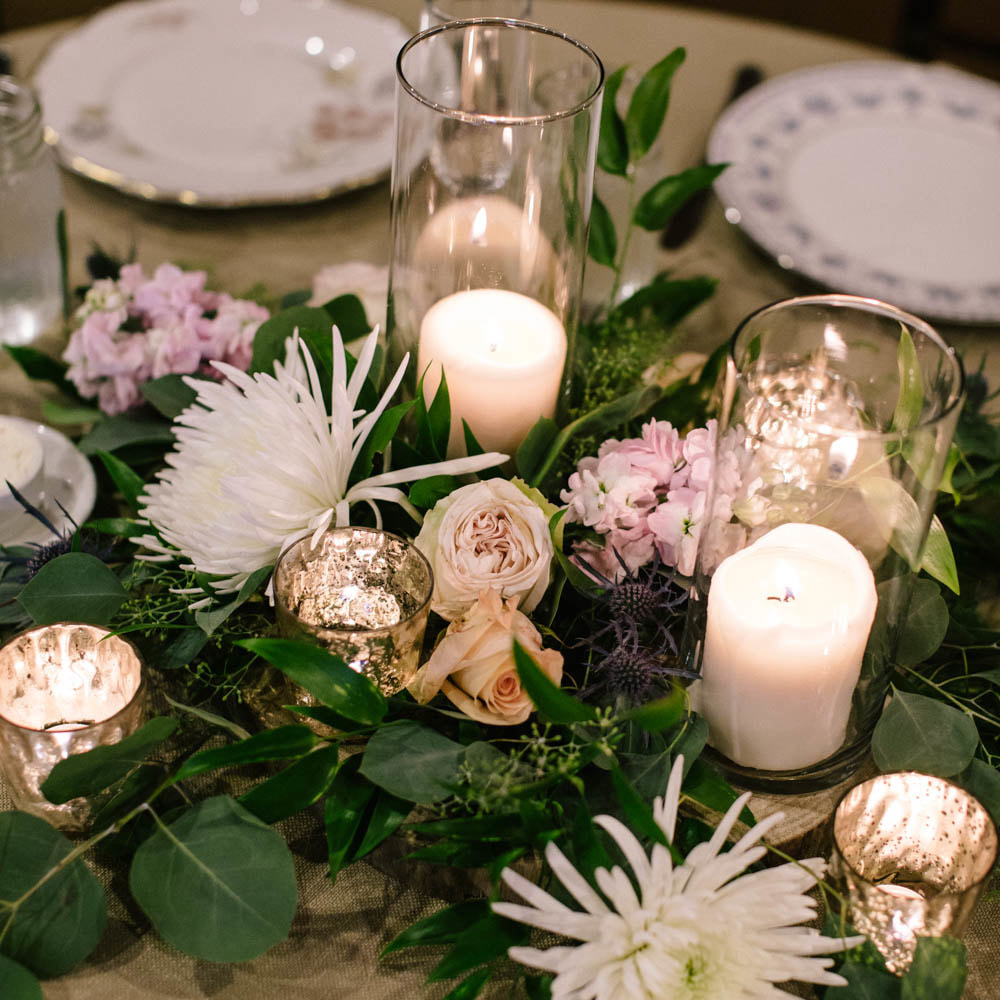 Gold pillar candle centerpieces with floral, mismatched china, gold table numbers, reception detail photos at spruce mountain ranch, denver wedding planning, colorado wedding planner, destination wedding planner, sweetly paired weddings, sweetheart table