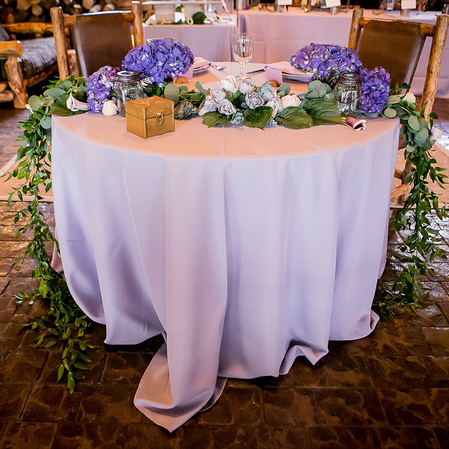 colorado room reception details, sweetheart table, blue hydrangea centerpieces, greenery swag, spruce mountain ranch weddings, real weddings, mountain wedding planning, colorado wedding inspiration