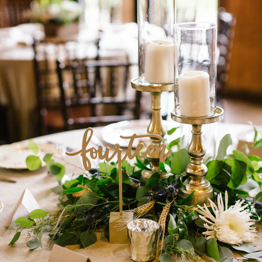 Gold pillar candle centerpieces with floral, mismatched china, gold table numbers, reception detail photos at spruce mountain ranch, denver wedding planning, colorado wedding planner, destination wedding planner, sweetly paired weddings