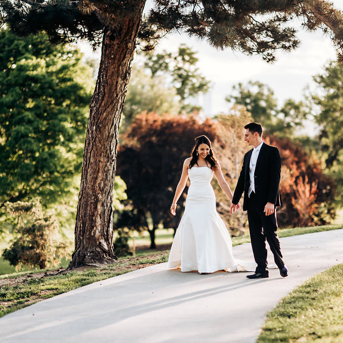Bride and groom portrait, walking holding hands in city park, denver wedding planner, colorado wedding planner, classy formal real weddings, sweetly paired