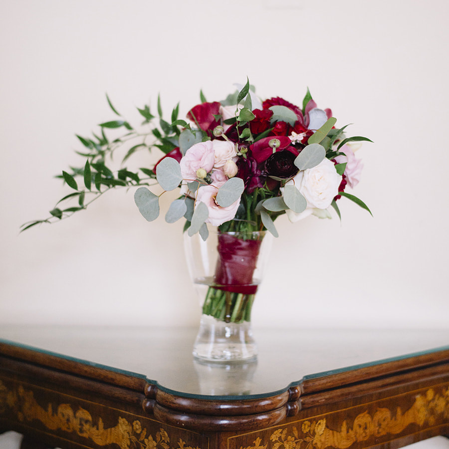 bridal bouquet in vase on antique wood table, detail photos, cherokee ranch wedding planner, colorado wedding inspiration, chic mountain wedding decor