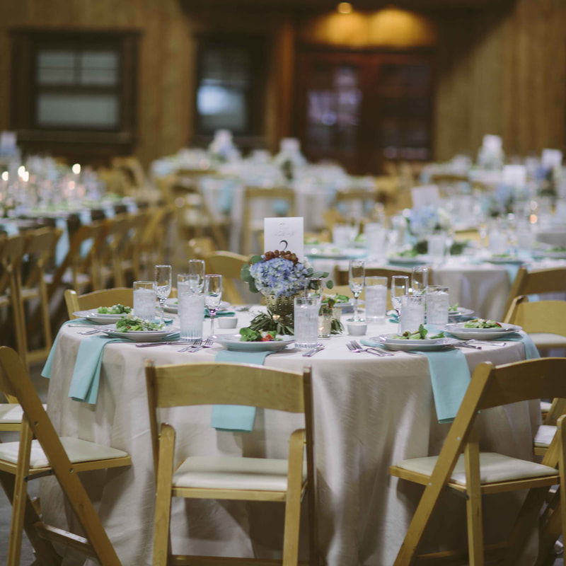 spruce mountain ranch reception decor, centerpieces with blue hydrangeas and grapes, robins egg blue linens, waterfall napkins, colorado mountain wedding, sweetly paired wedding planners, summer wedding inspiration