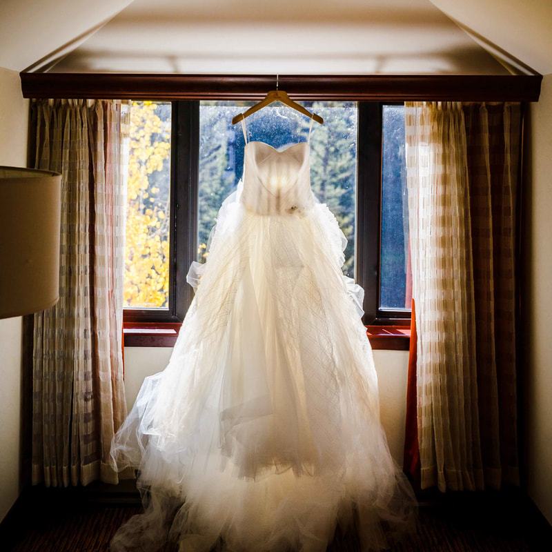 wedding dress hanging in window, bridal suite, bride getting ready, vail wedding planning, colorado wedding planner, sweetly paired weddings, top mountain wedding planners