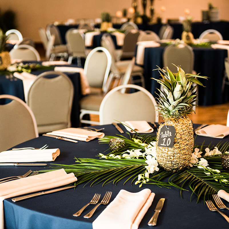 reception table decor, gold pineapple centerpieces, palm fronds, gold navy and green wedding colors, cielo at castle pines reception, colorado wedding inspiration, mountain wedding planner