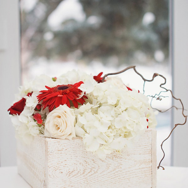 Red floral centerpieces in square wooden boxes, reception detail photos at sonnenalp, vail wedding planning, colorado wedding planner, destination wedding planner, sweetly paired weddings, mountain wedding inspiration, christmas themed wedding decor, winter weddings
